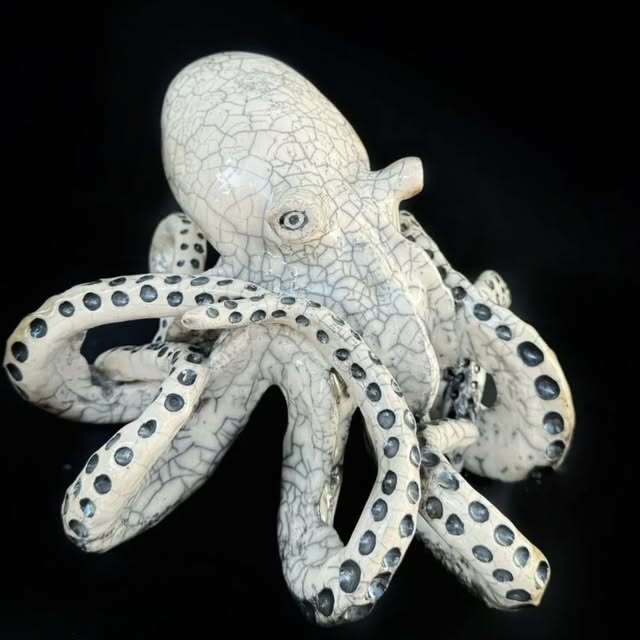 White sculptural ceramic octopus with dark blue details